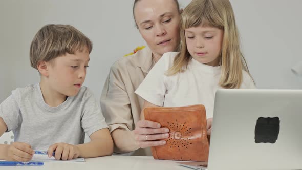 Mother and Two Children are Purchasing Something Online alt
