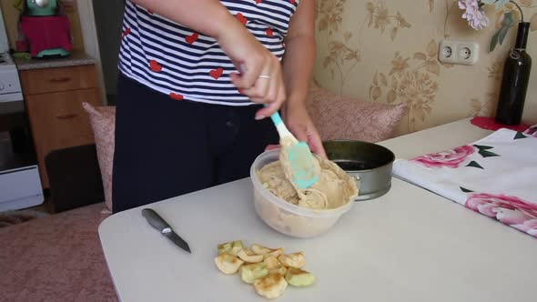 A Woman Stirs The Dough For An Apple Pie. Cooking Charlotte At Home.