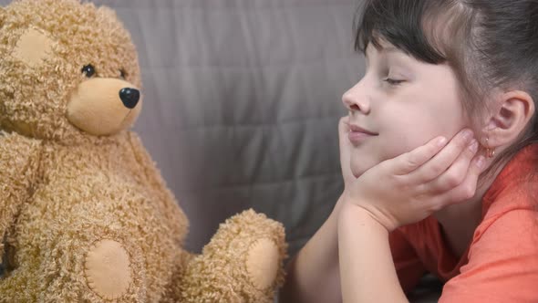 Lay on Sofa with Teddy Bear alt