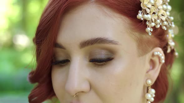 Beautiful Redhead Woman Raises Her Green Big Eyes and Looks Directly Into Camera alt