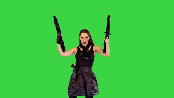 Cyberpunk Girl in Black Military Clothes Poses with Machine Guns and Goes Away on a Green Screen