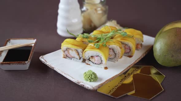 Close-up, mango sushi set on white clay plate alt