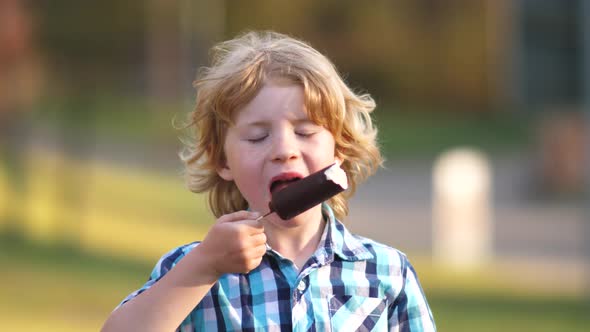 Young Blond Boy Eating a Ice Cream