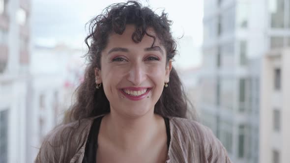 Young woman laughing at camera alt
