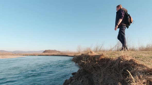 A Man Stands On The River Bank alt