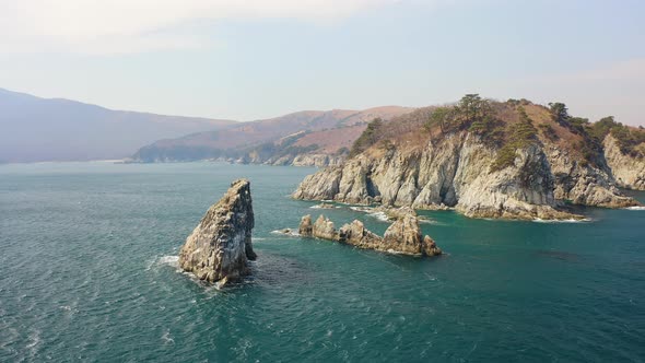 Kekura and Rocky Cape Telyakovsky Washed By the Sea of Japan on a Sunny Day alt