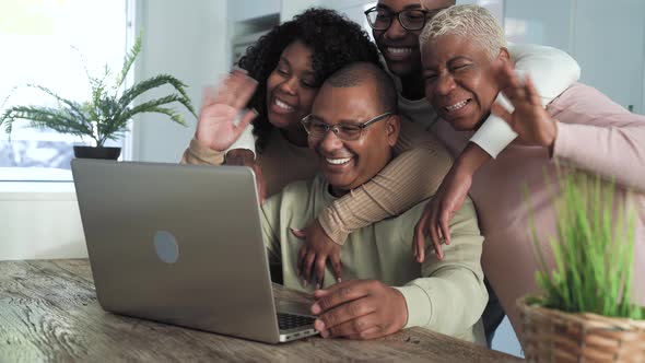 Happy black family having fun doing video call using laptop at home during corona virus outbreak alt