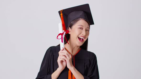 Beautiful Attractive Asian woman graduated in cap and gown smile alt