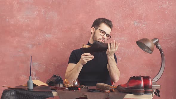Young Man Checking the Glued Sole alt