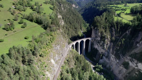 Landwasser Viaduct in Swiss Alps in Summer Aerial View on Green Mountain Valley alt
