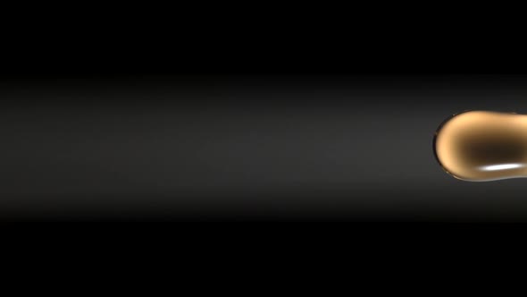 Chocolate milk spinning and falling against black background. Slow Motion. alt