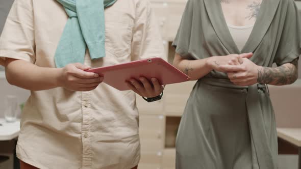 Two Unrecognizable Colleagues Going along Office and Having Talk alt