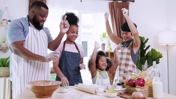 African American family with little adorable daughters thresh dough  together