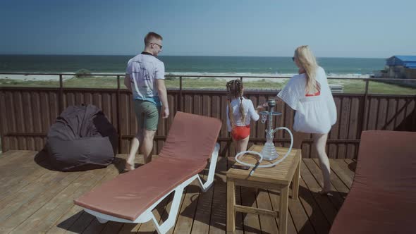 Joyful Family Walks To Handrails To Admire Endless Ocean
