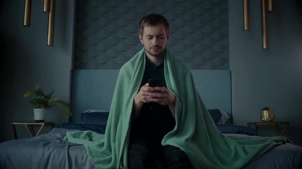 Sick Man Having a Flu Cold Use Smartphone alt