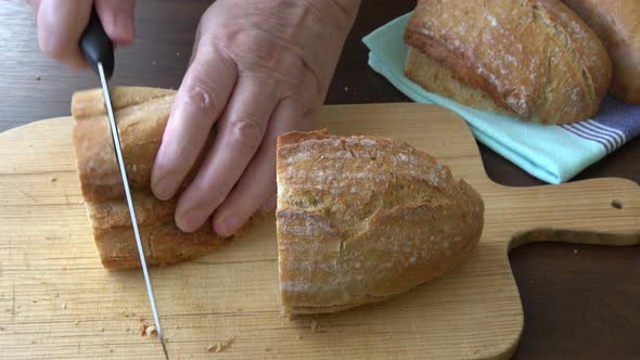 Female hands slicing home-made bread