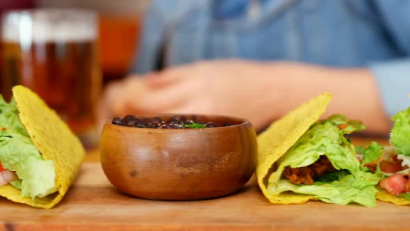 Mid section of friends having beer at table 4k alt