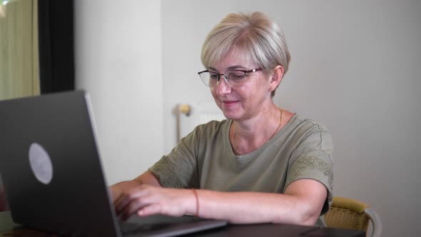 A Programmer is Writing Program Code on the Laptop