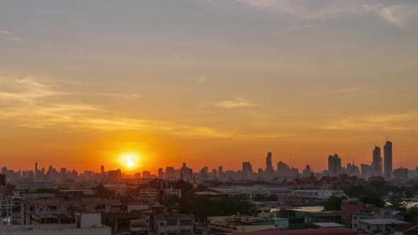 Dramatic sunrises over Bangkok downtown, night to day, zoom out - time lapse