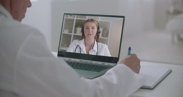 Online Medical Lecture in Video Conference on Display of Laptop, Woman Is Teaching and Man Is alt