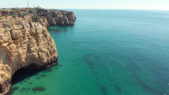 Vast turquoise ocean bared by Steep eroded cliffs in Lagos coast, Algarve, Portugal alt