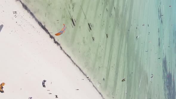 Vertical Video Kitesurfing Near the Shore of Zanzibar Tanzania Aerial View alt