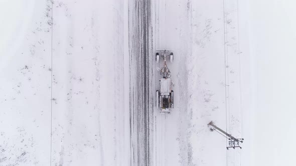Top down Aerial view of Snowblower Grader Clears Snow Covered Country Road 07 alt