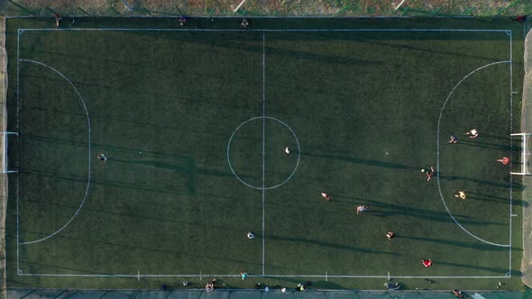 Aerial Shot Two Teams Playing Ball in Football Outdoors, Top View, Football Game Outdoors, Green alt