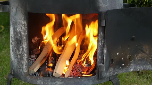 Burning Wood in the Fireplace. Man Burning Fireplace for Cooking