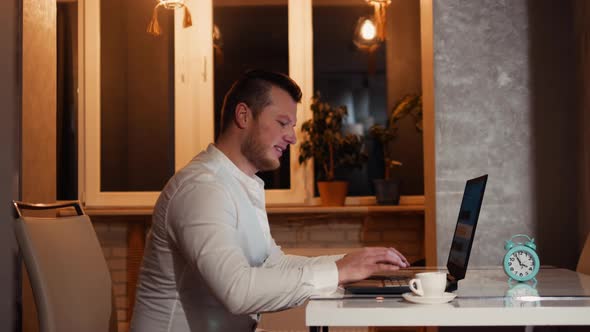 Young Freelancer I A Cozy Home Atmosphere With A Cup Of Coffee Works At Home At The Work Table alt