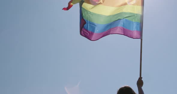 Pride LGBT rainbow flag waving in slow motion during a pride parade