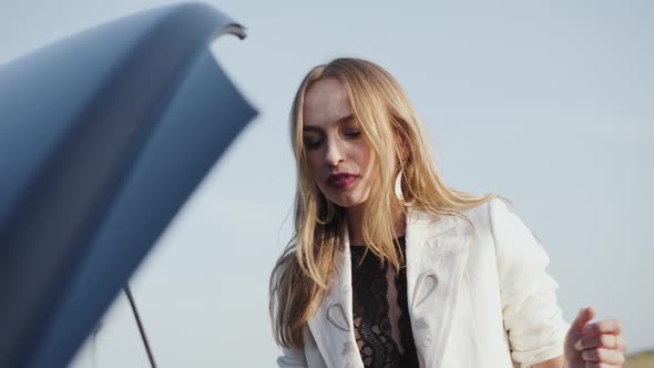 Portrait of Confused Woman Tries to Understand the Reason of Car Breakage alt