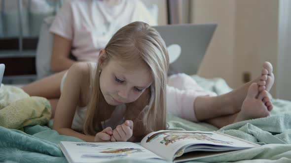 Little Girl Reading a Book