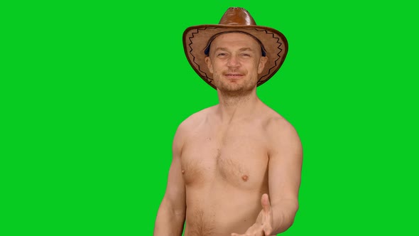 Charming Cheerful Adult Man In Cowboy Hat Blowing A Kiss on Green Screen