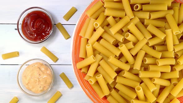Uncooked Raw Italian Rigatoni Pasta Rotating Slowly on Turntable in Dish alt
