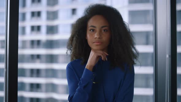 Thoughtful African American Executive Woman Looking Camera in Corporate Office alt