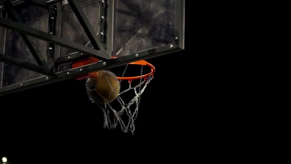 Basketball player scores a goal on the arena. Basketball Court. The decisive moment of the game. alt