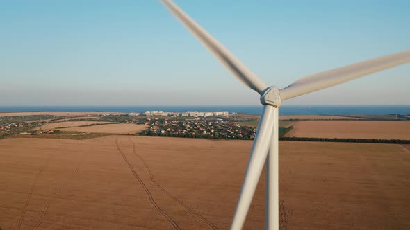 An Aerial Drone Closeup Shot of Windmill in Rural Fields Generating Renewable Energy alt