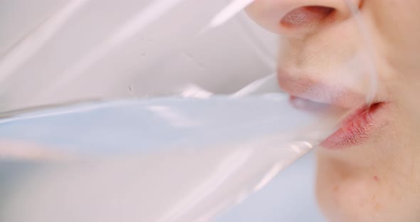 Extreme Close Up of Woman Drinking Glass of Water alt