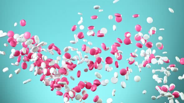 Super Slow Motion Shot of Flying Colorful Pills on Light Blue Background at 1000Fps. alt