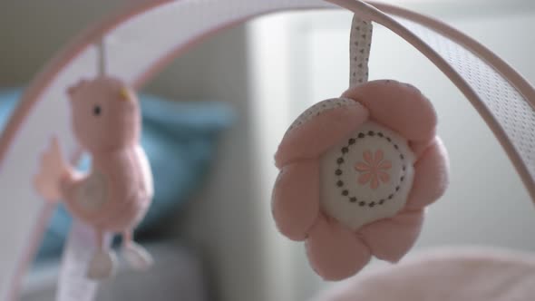 Baby Toys Hanging Over the Bassinet and Swinging alt
