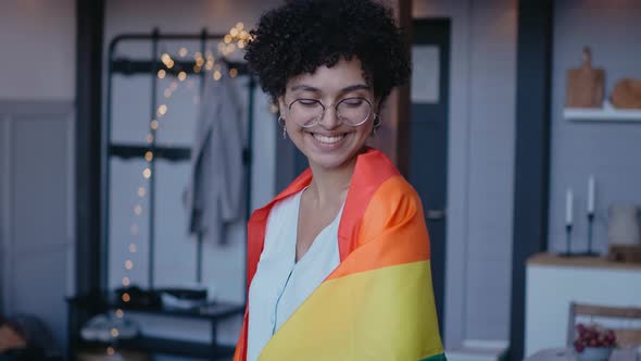 Black Girl Wears Lgbt Flag on Her Shoulders Looking at the Camera Smiling
