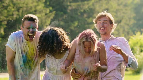 Group of Friends Covered in Colored Paint Enjoying Time at Summer Pool Party alt