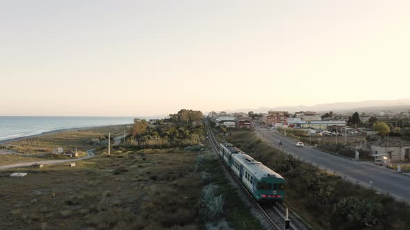 Aerial view of train passing near the cost alt