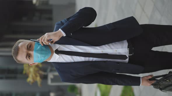 Businessman in Medical Mask Talking on Phone. COVID-19 Coronavirus Infection alt