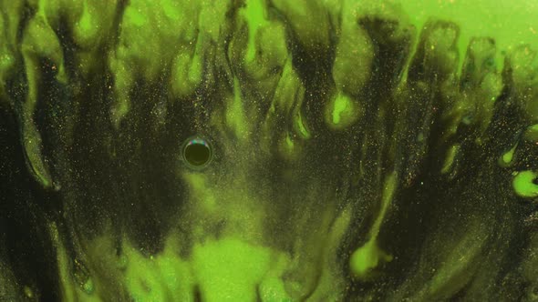 Neon light green and black colors oil paint pouring close up. Fluid Art painting