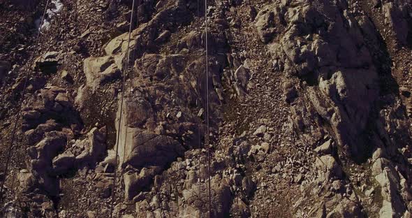 Cable Car View of Rocky Mountain Ground Beautiful Snowy Mountain Range Landscape in Background in a alt