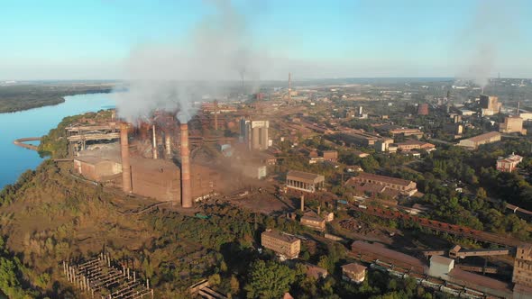Aerial View of the Industrial Plant with Smoking Pipes Near the City. Industrial Zone alt