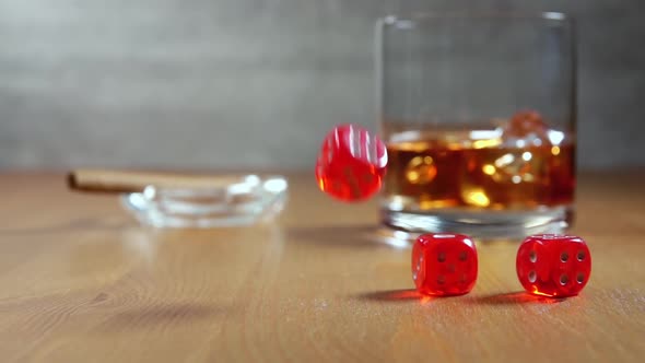 Dice on a Wooden Table and Glass of Whiskey