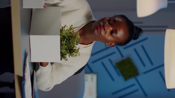 Sad African Fired Businesswoman Packing Things in Box Being Dismissed From Job alt